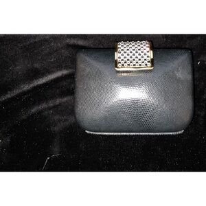 Beautiful black clutch with black and white trimmed in gold latch.